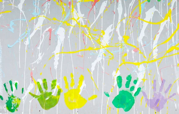 Colored hand prints on wall