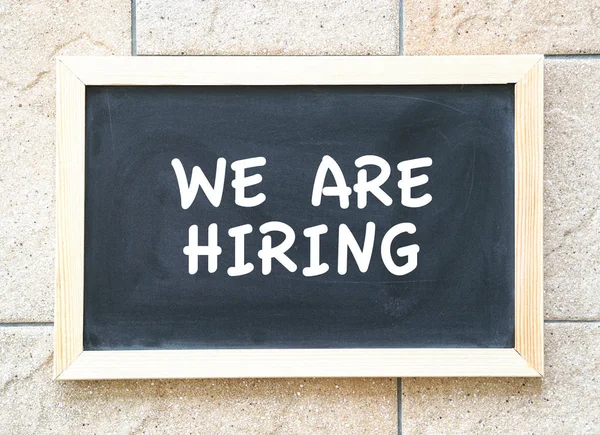 We are hiring, words printed on blackboard — Stock Photo, Image