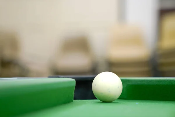 Pool ball on green table close up