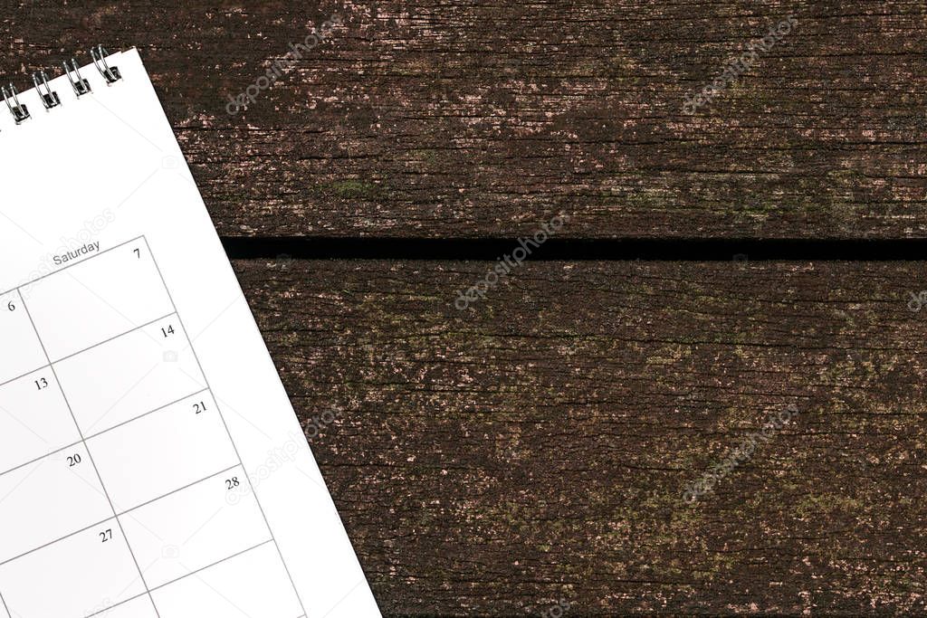 Calendar or planner on dark wood background