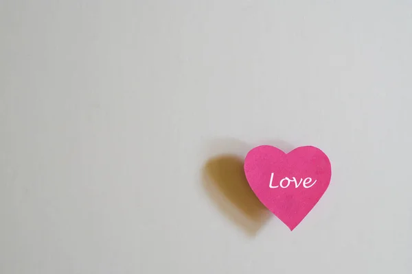 Love concept: Paper heart shape with the word Love on white back — Stock Photo, Image