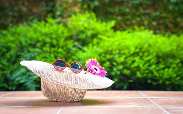 Strand mössa med solglasögon och Gerbera daisy blommor — Stockfoto