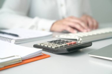 Office table view with Accountant or Woman Executive out of focu