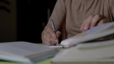 Bir not defterine kitap yazan bir kadın..
