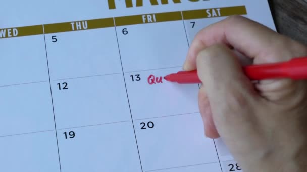 女性は言葉を書き カレンダーに赤いペンで仕事をやめる — ストック動画