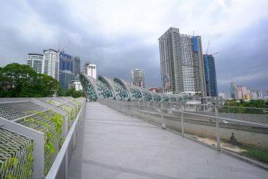 Kuala Lumpur, Malaysia - June 11, 2020: Saloma Link pedestrian bridge connecting Kampung Baru and KLCC Malaysia. A new tourists landmark too. clipart