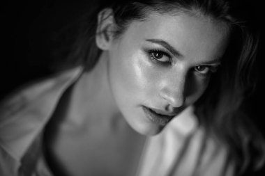 Classic portrait of sensual young woman in a simple clothes. Emotional close-up photo clipart