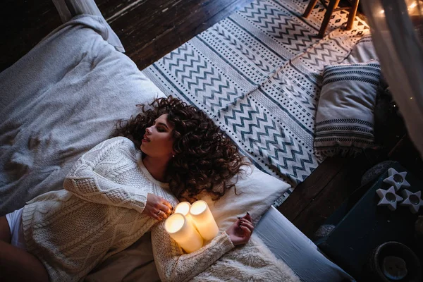 Pretty young woman in a room with christmas decoration. Winter mood, cozy home, scandinavian style