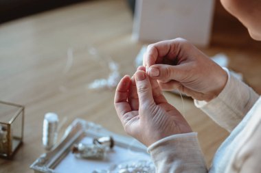 Closeup makro fotoğraf ayrıntıları, dekoratör işyeri ve İmitasyon Takı düğün yaratıcısı. Kadının elinde bir süreç oluşturma