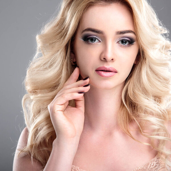Beauty portrait of blonde beautiful woman with perfect makeup and hair style, isolated. Spa and hair, healthy skin