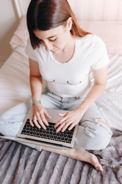 feminist woman with breasts drawn on shirt writing on laptop