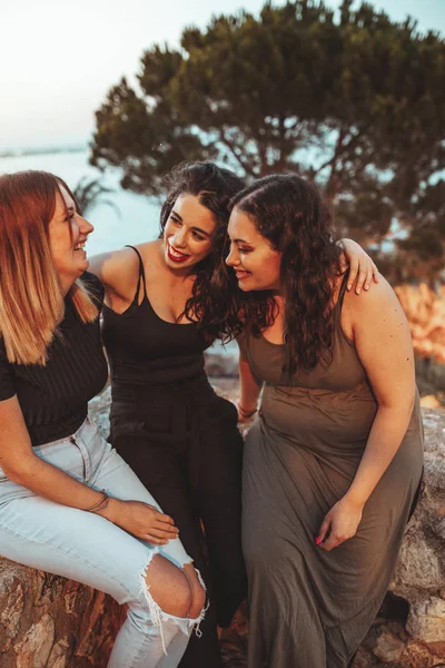Trzy piękne dziewczyny mają dobry czas w pobliżu plaży o zachodzie słońca — Zdjęcie stockowe