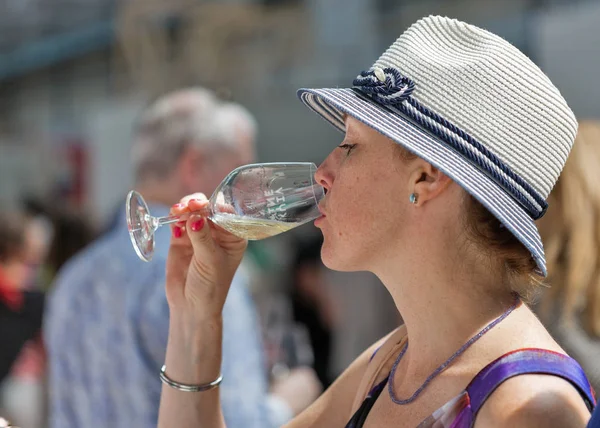 Kiev, Ukrayna - 2 Haziran 2018: Çiller şapkalı olan kadın Kiev Şarap Festivali beyaz şarap tadı. dünyanın dört bir yanından gelen 77 winemakers iyi şarap şirketi tarafından düzenlenen festival big aldı