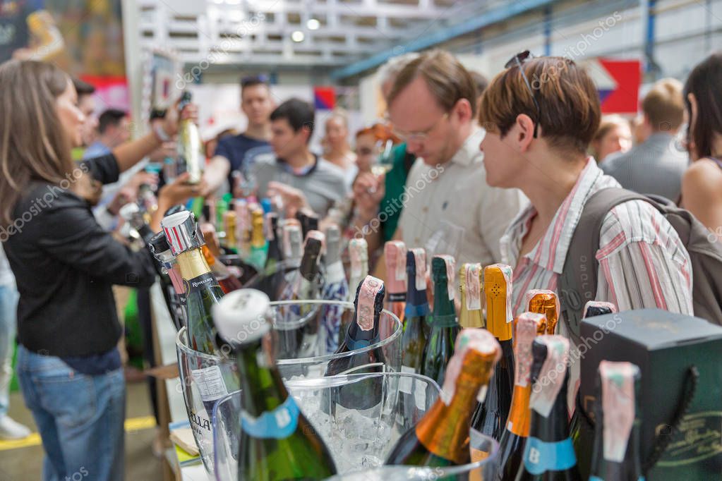 KIEV, UKRAINE - JUNE 02, 2018: People visit sparkling wine booth at Kyiv Wine Festival. 77 winemakers from around the world took part in the big festival organized by Good Wine company.