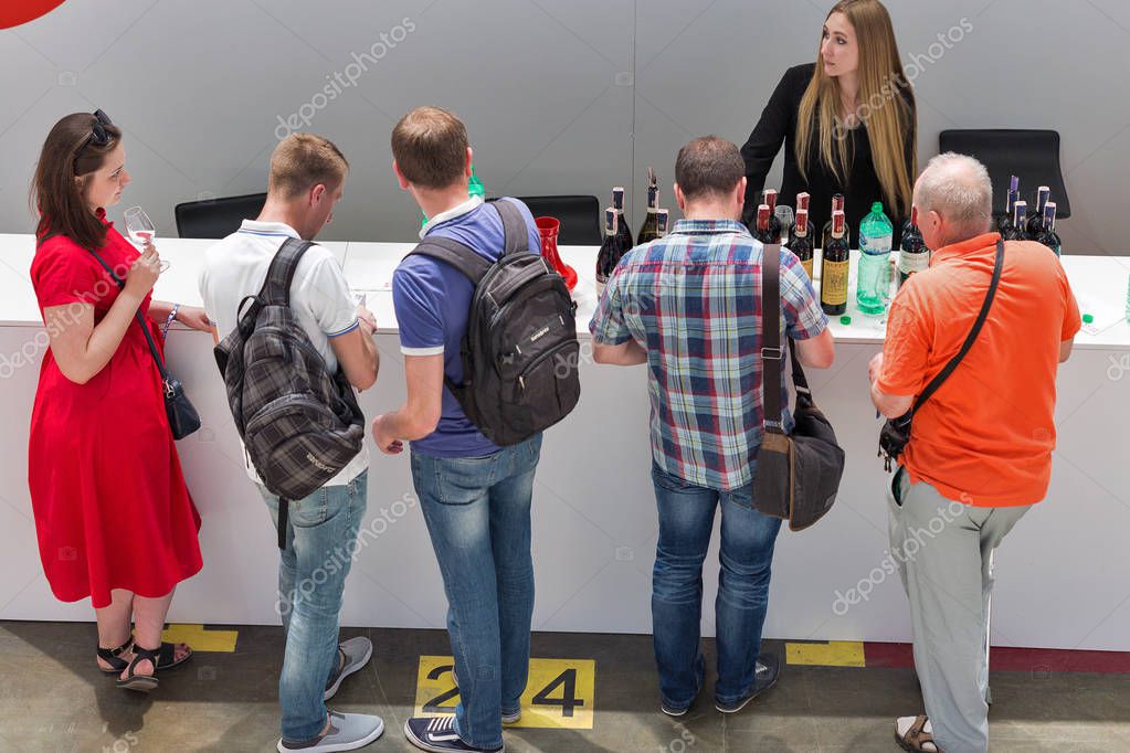 KIEV, UKRAINE - JUNE 02, 2018: People taste wine at Kyiv Wine Festival boothes. 77 winemakers from around the world took part in the big festival organized by Good Wine company.