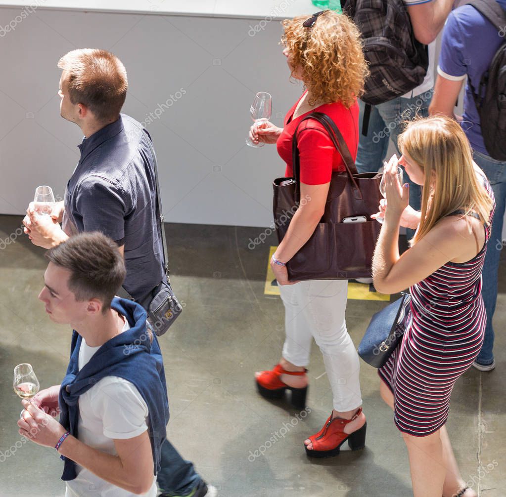 KIEV, UKRAINE - JUNE 02, 2018: People taste wine at Kyiv Wine Festival boothes. 77 winemakers from around the world took part in the big festival organized by Good Wine company.