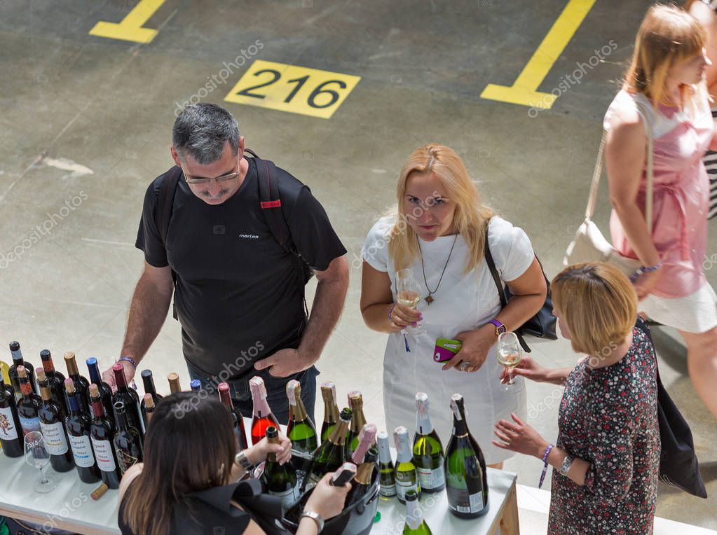 KIEV, UKRAINE - JUNE 02, 2018: People taste wine at Kyiv Wine Festival boothes. 77 winemakers from around the world took part in the big festival organized by Good Wine company.