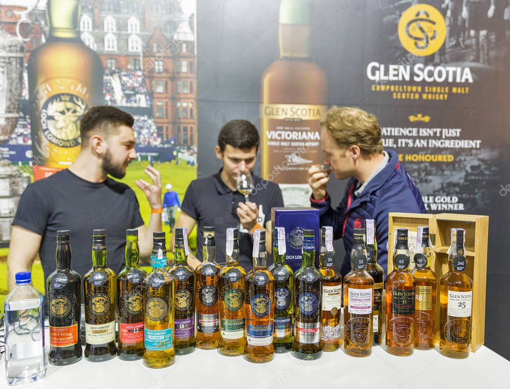 KIEV, UKRAINE - OCTOBER 20, 2018: Presenters work at Glen Scotia Scotch highland single malt whisky booth at 4th Ukrainian Whisky Dram Festival organized by Good Wine company in Artistic Arsenal.