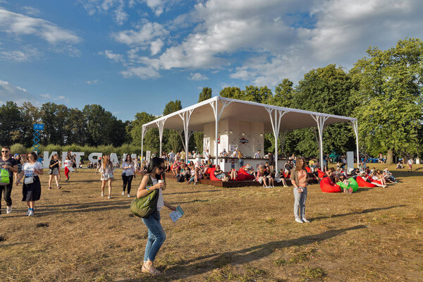 KIEV, UKRAINE - JULY 07, 2018: People visit Martini outdoor bar at the Atlas Weekend Festival in National Expocenter. Bacardi is the largest family owned spirits company in the world.