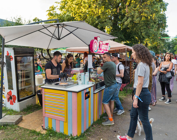 KIEV, UKRAINE - JULY 08, 2018: People visit outdoor Tigerroll Thai ice cream stall at the Atlas Weekend Festival in National Expocenter. Atlas Weekend is popular annual music and arts festival.