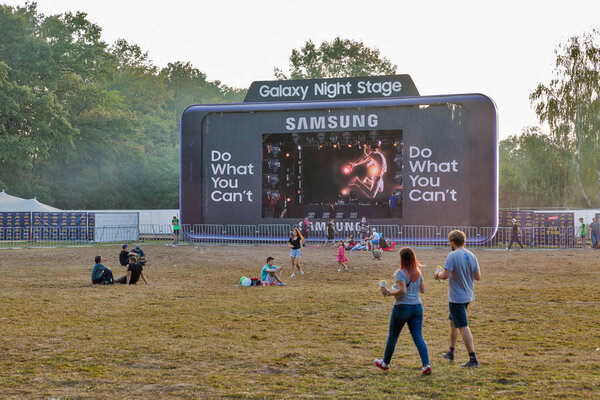 KIEV, UKRAINE - JULY 08, 2018: People visit Samsung Galaxy Night Stage at Atlas Weekend Festival in National Expocenter. The Atlas Weekend is a popular annual modern music and arts festival.