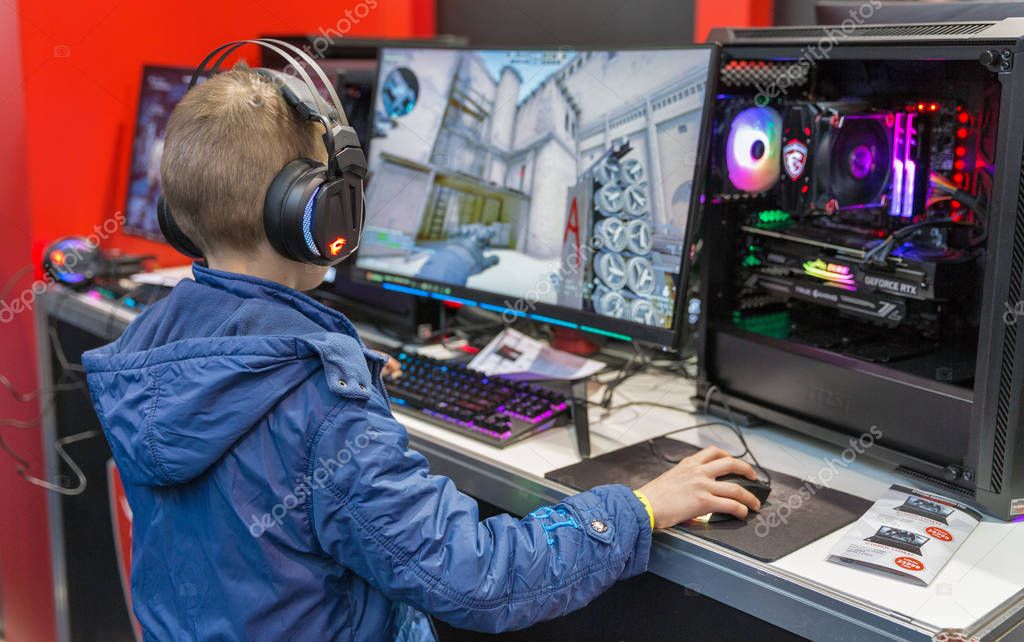 KYIV, UKRAINE - APRIL 06, 2019: Young boy visit MSI, a Taiwan based information technology corporation booth during CEE 2019, the largest electronics trade show of Ukraine in Tetra Pack EC.