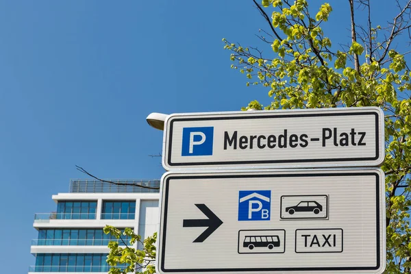 Road city signpost to Mercedes Square in Berlin, Germany.