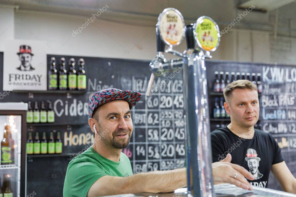 KYIV, UKRAINE - MAY 18, 2019: Friday craft brewery bartenders work at Kyiv Beer Festival vol. 4 in Art Zavod Platforma. More than 60 craft beer breweries were presented here.