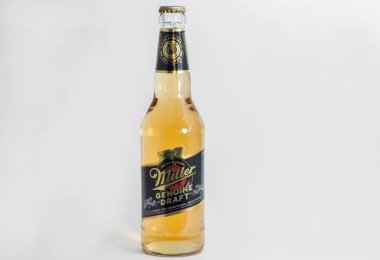 KYIV, UKRAINE - JUNE 17, 2020: Miller Genuine Draft lager beer bottle closeup against white background. Miller Brewing Company is an American beer company headquartered in Milwaukee, Wisconsin. clipart