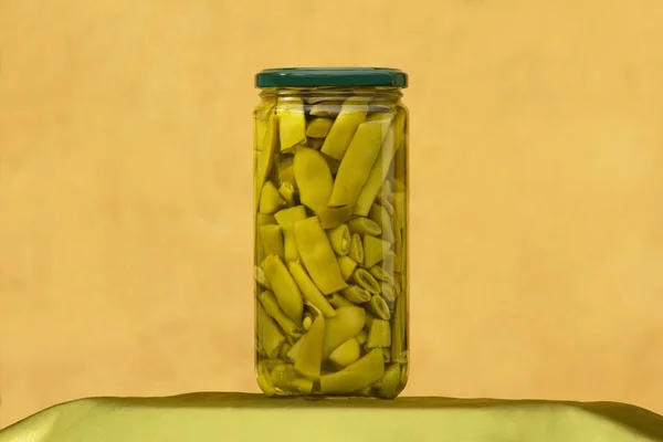 Jar Glass Container Showing Green Canned Beans Ocher Wall Background — Stock Photo, Image