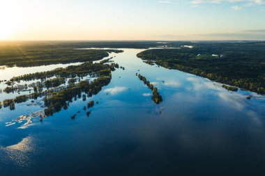 Nehirde bahar seli, sel basmış orman, nehirdeki adalar. İnsansız hava aracı, kuş bakışı görüntü. Akşamları insanların yokluğuna bak..