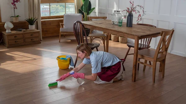 woman do cleaning and wash floors with the mop in the room