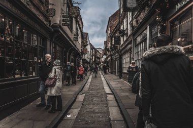 YORK, ENGLAND, DECEMBER 12, 2018: people walking in the famous The Shambles street. clipart
