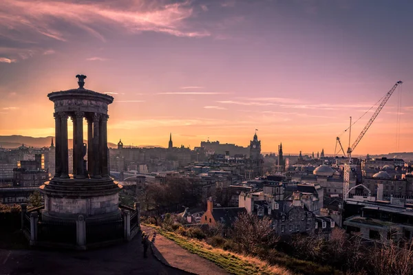 2018年12月14日，苏格兰爱丁堡：在包括爱丁堡城堡和北桥在内的爱丁堡市中心城市景观的前景中的杜加德斯图尔特纪念碑美丽的落日 — 图库照片