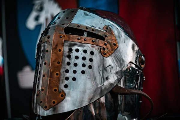 BUENOS AIRES, ARGENTINA, MAY 4, 2019: Shiny silver medieval iron knight helmet with a golden cross, full of scratches due to battles — Stock Photo, Image
