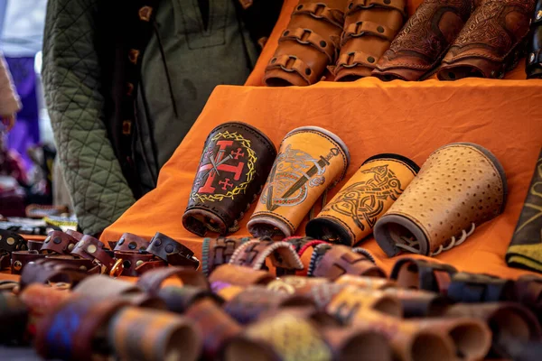 Sales stand with engraved leather bracers of medieval age — Stock Photo, Image