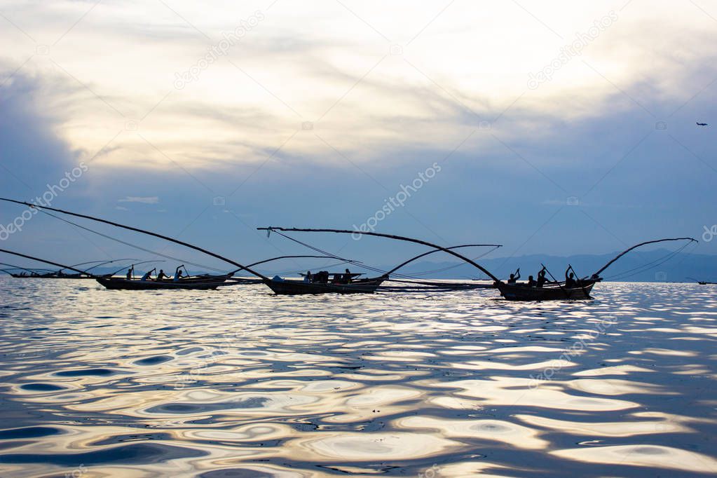 Lake Kivu, Rwanda: Fishermen in Traditional Fishing Boats on the Lake with the Sun's Reflection on Water