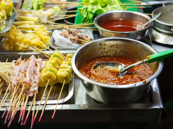 Asian street Food. People cooking, selling and buying Exotic Asian Food (Thai, Malaysian, Chinese, Korean, Japanese). Exotic delicious Street food, especially seafood are very popular among tourists