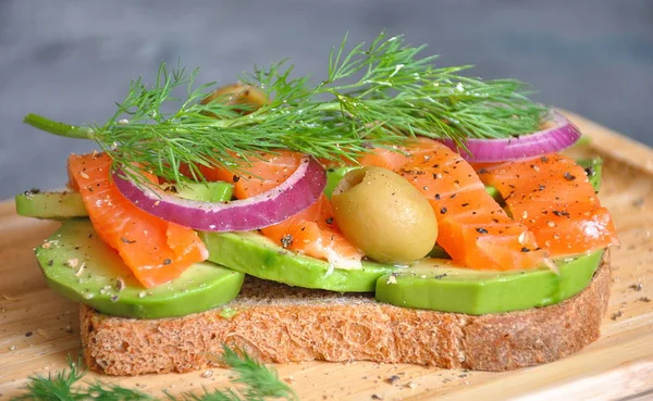 Avokado ve somon sağlıklı tam tahıllı ekmek tost. Sağlıklı besleyici yemek. Somon Sandviç 