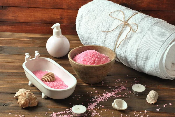 Spa and body care products. Aromatic rose bath Dead Sea Salt on the dark wooden background. Natural ingredients for homemade body salt scrub. Dead Sea cosmetics. Beauty skin care. Spa treatment.