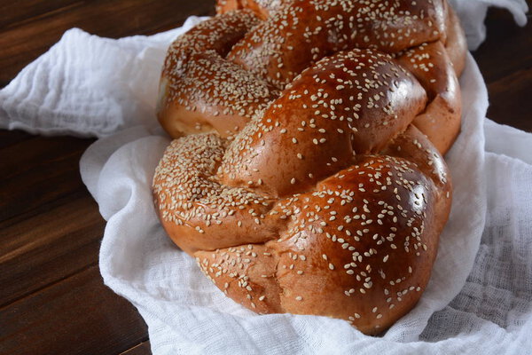 Homemade challah bread with sesame seeds. Jewish traditional bread for Shabbat 