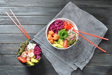 Organik gıda. Taze deniz ürünleri tarifi. Somon, karides, pirinç, kırmızı lahana, avokado, kiraz domates ve turp lahanası ahşap arka plan taze poke kase. Gıda kavramı Poke Bowl 