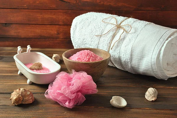 Spa and body care products. Aromatic rose bath Dead Sea Salt on the dark wooden background. Natural ingredients for homemade body salt scrub. Dead Sea cosmetics. Beauty skin care. Spa treatment.