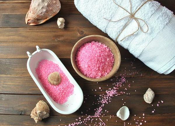 Spa and body care products. Aromatic rose bath Dead Sea Salt on the dark wooden background. Natural ingredients for homemade body salt scrub. Dead Sea cosmetics. Beauty skin care. Spa treatment.