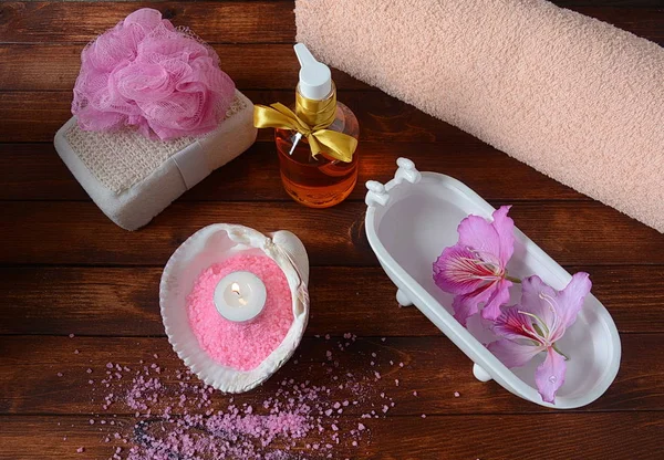 Spa and body care products. Aromatic rose bath Dead Sea Salt on the dark wooden background. Natural ingredients for homemade body salt scrub. Dead Sea cosmetics. Beauty skin care. Spa treatment
