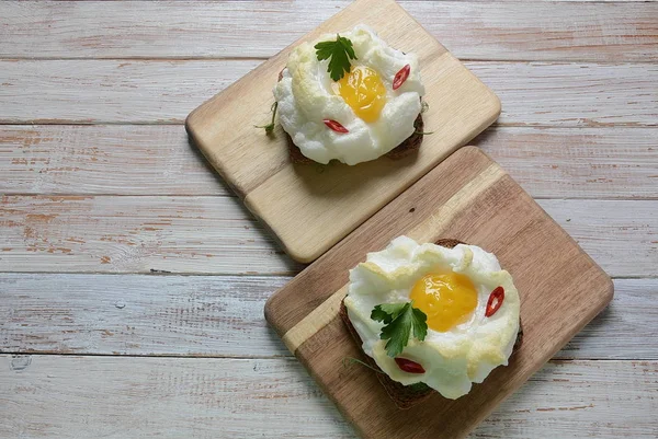 Delicate baked egg. Orsini eggs in the cloud. French breakfast.Cloud egg on toast