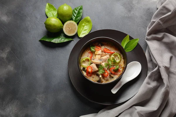 Thai style coconut milk soup-Tom Kha Gai with chicken,mushrooms, galangal, lime leaves, lemongrass, chili peppers. Thai cuisine food concept