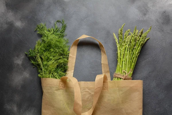 Reusable zero waste textile product bag filled with green asparagus