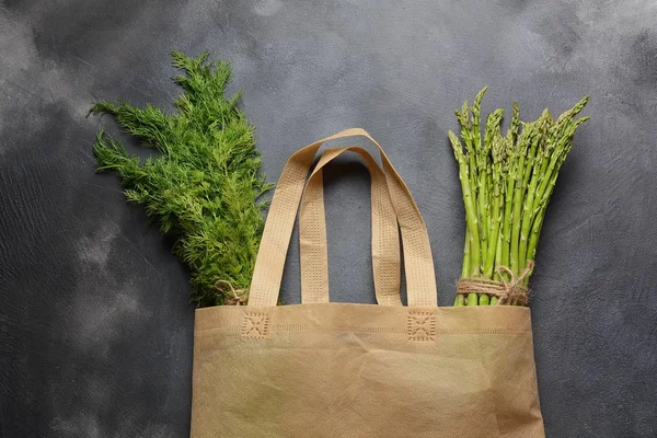 Reusable zero waste textile product bag filled with green asparagus