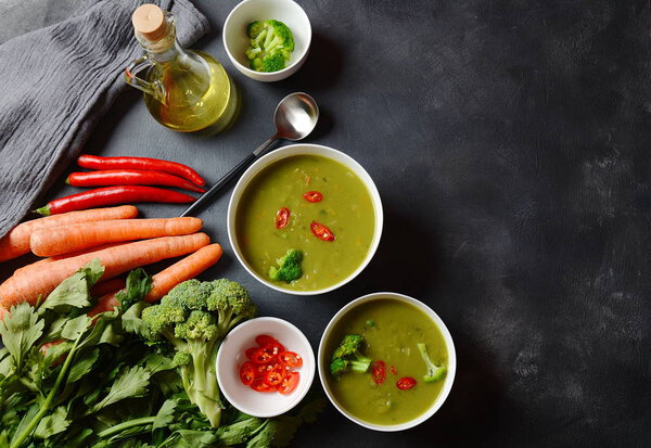 Healthy Vegan Creamy blended vegetable Soup puree with broccoli, celery, peas and carrots . Green detox soup concept. Low-fat lunch.